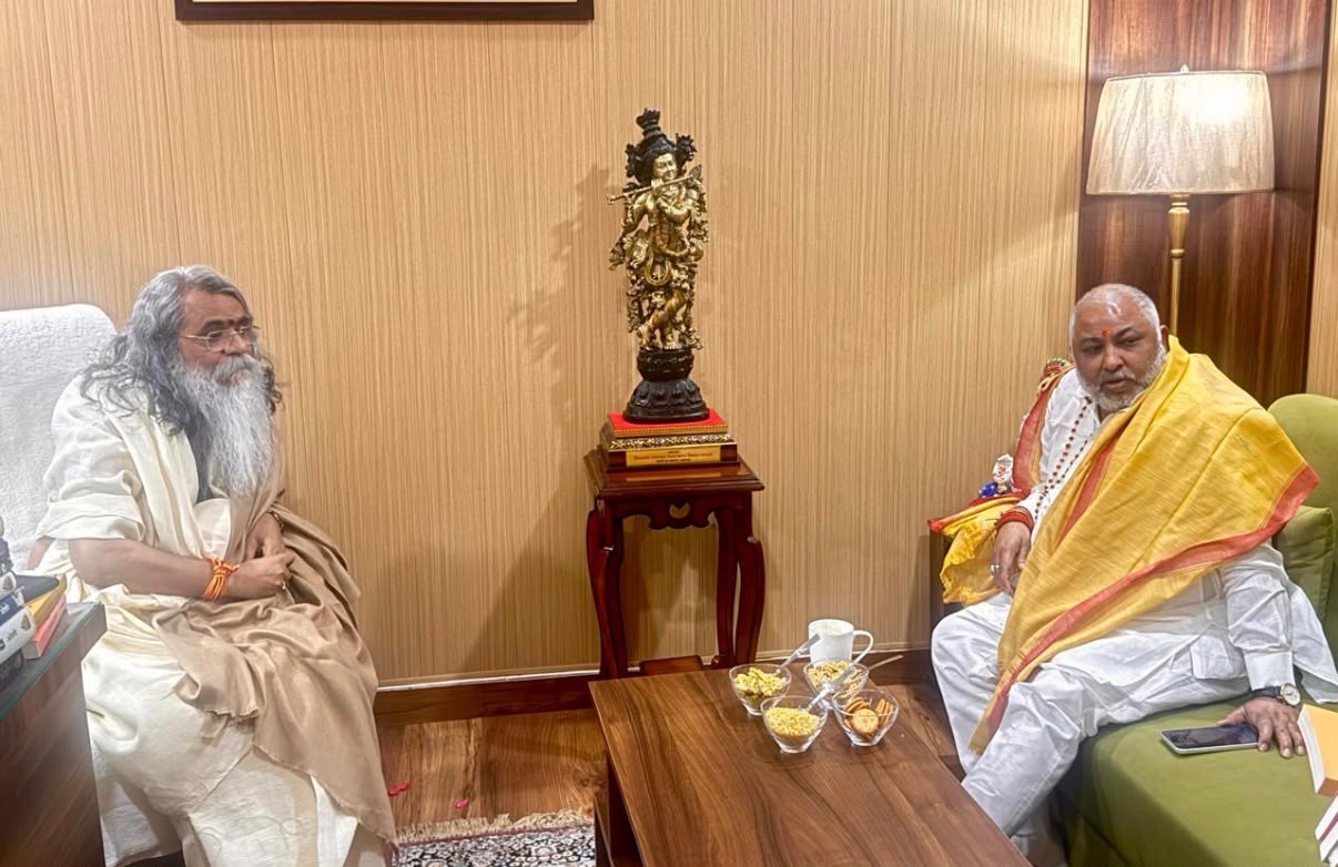 Conversation beside a murti of Shri Krishna